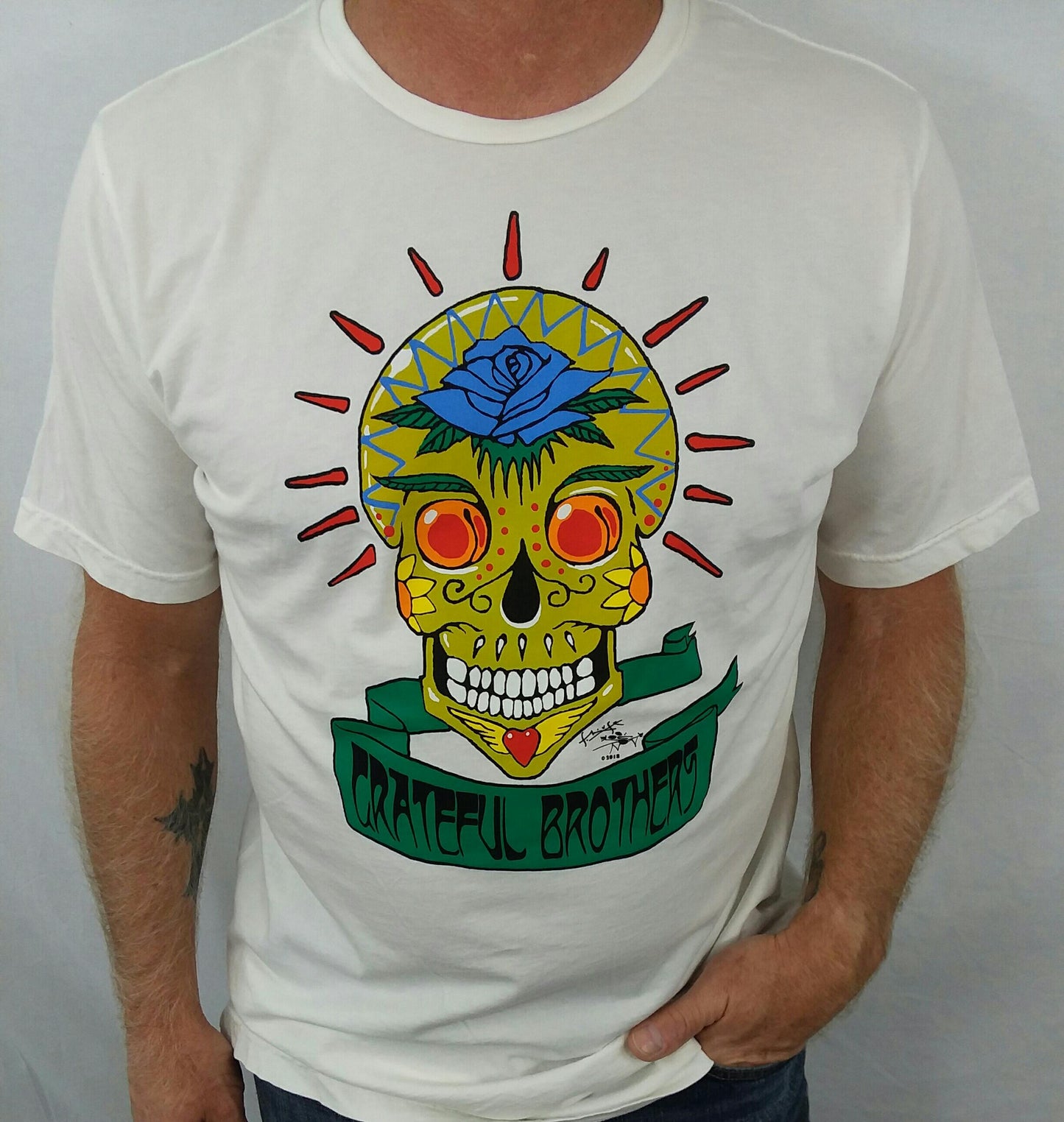 The Grateful Brothers white skull t-shirt on model designed by stanley mouse 100% organic made in america blue rose music